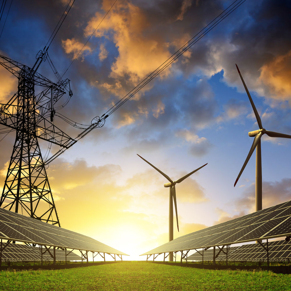 Solar panels with wind turbines and electricity pylon at sunset. Clean energy concept.